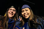 Selfie of Isamar and Mary on stage at the Doctoral Hooding Ceremony.